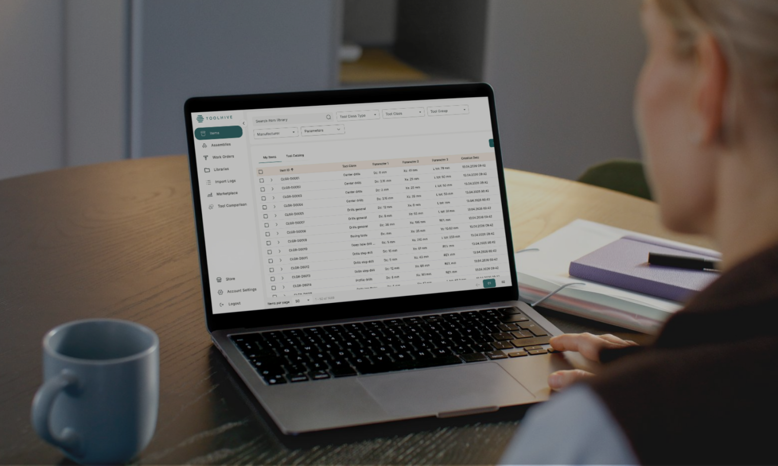 A person reviewing tool library data in Toolhive's cloud-based tool management software on a laptop