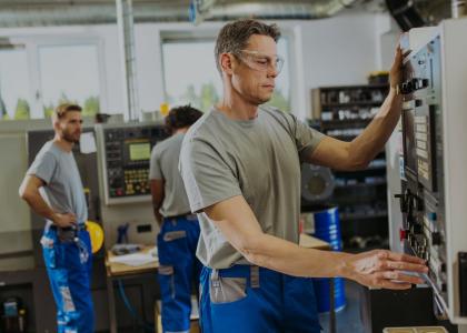 Man working on a CNC machine in a machine shop