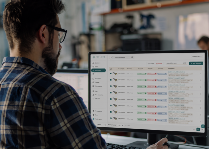 Programmer using Toolhive software to view and manage tool assemblies on a desktop monitor.