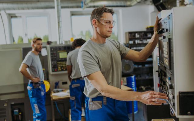 Man working on a CNC machine in a machine shop